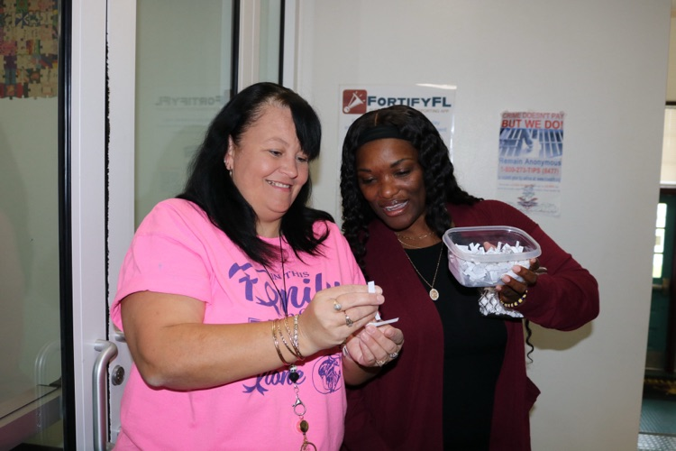 guidance counselor and nurse aid drawing a name