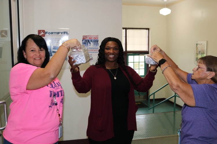 guidance counselor and two staff members drawing names