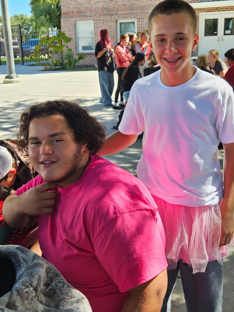 two students wearing pink
