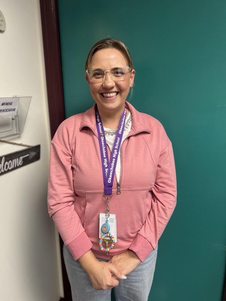 resource specialist wearing pink by the door