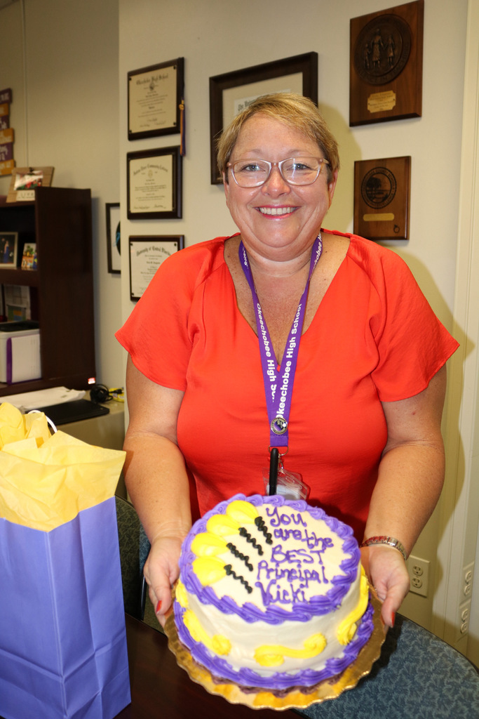 principal showing off her cake for boss day