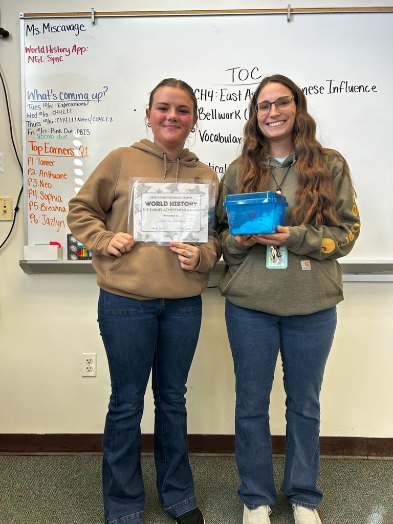 teacher with student holding certificate