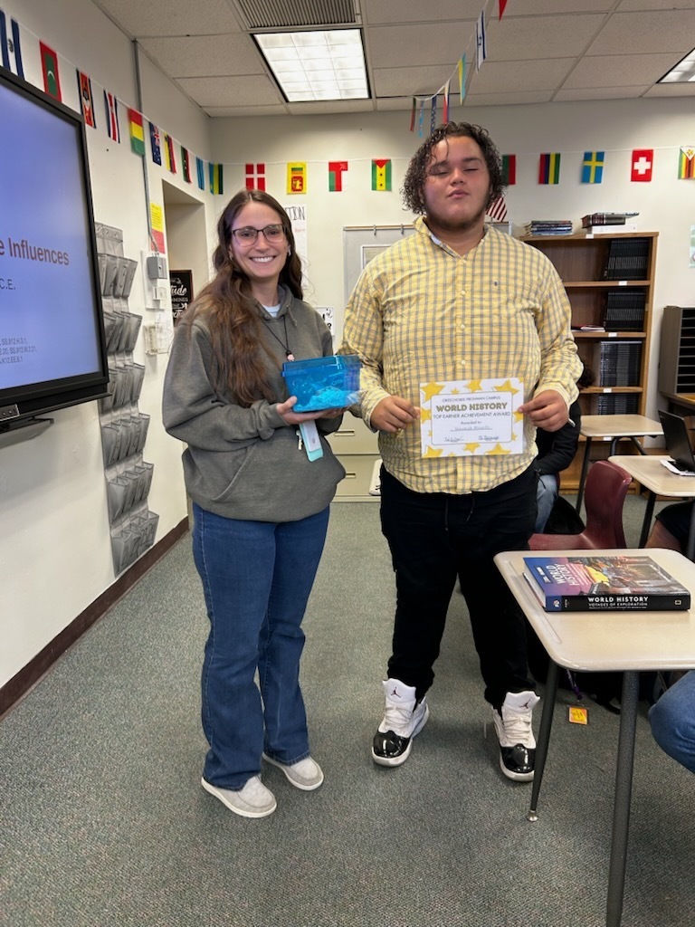teacher with student holding certificate
