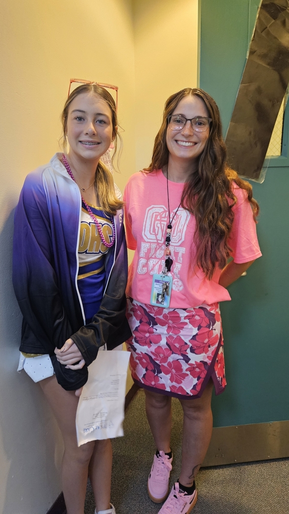 teacher standing by the door with cheerleader
