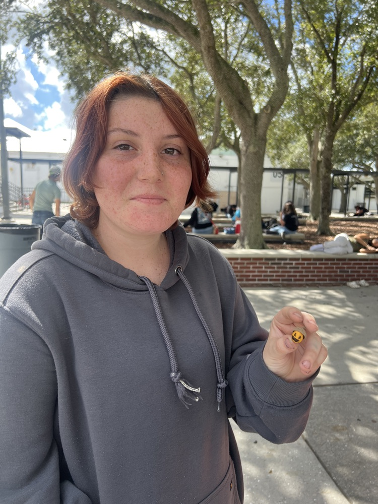 student showing off pumpkin acorn