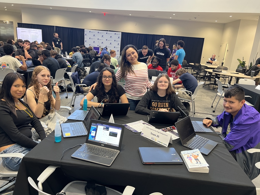 teacher with five students at cyber competition