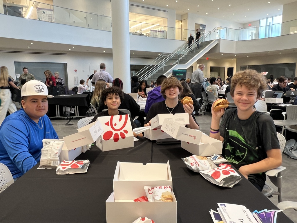 four students showing off chikfila