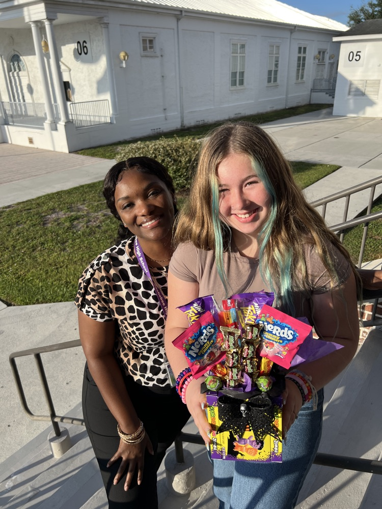 guidance counselor with student holding a candy basket