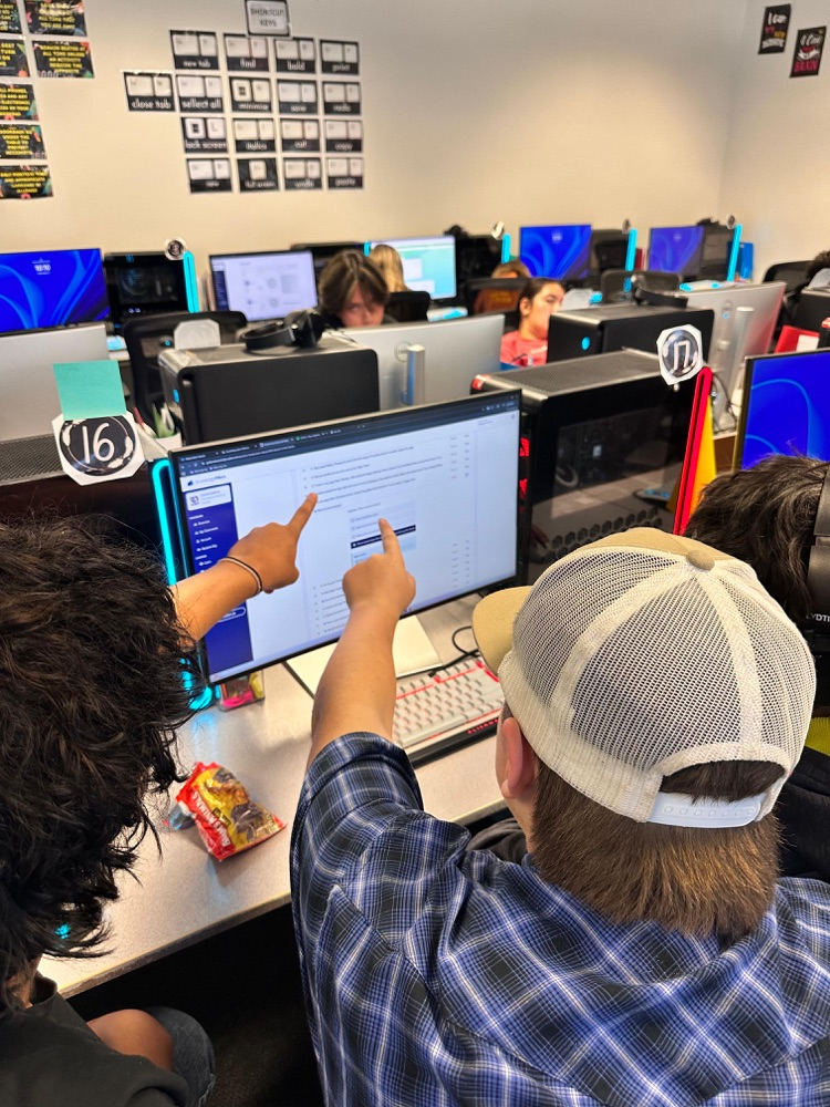 two boys pointing at screen