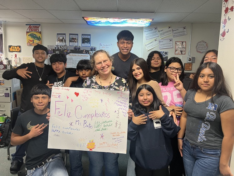 eleven students holding a poster for a teachers birthday