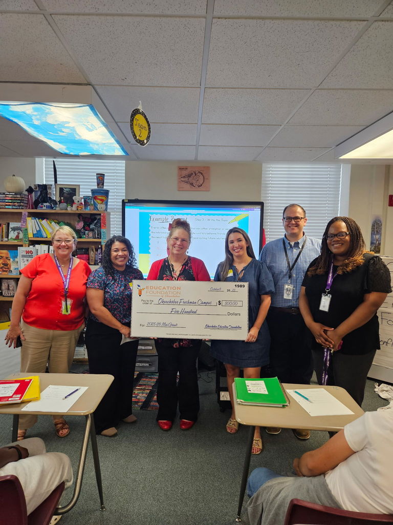 six teachers holding a 500 dollar grant certificate