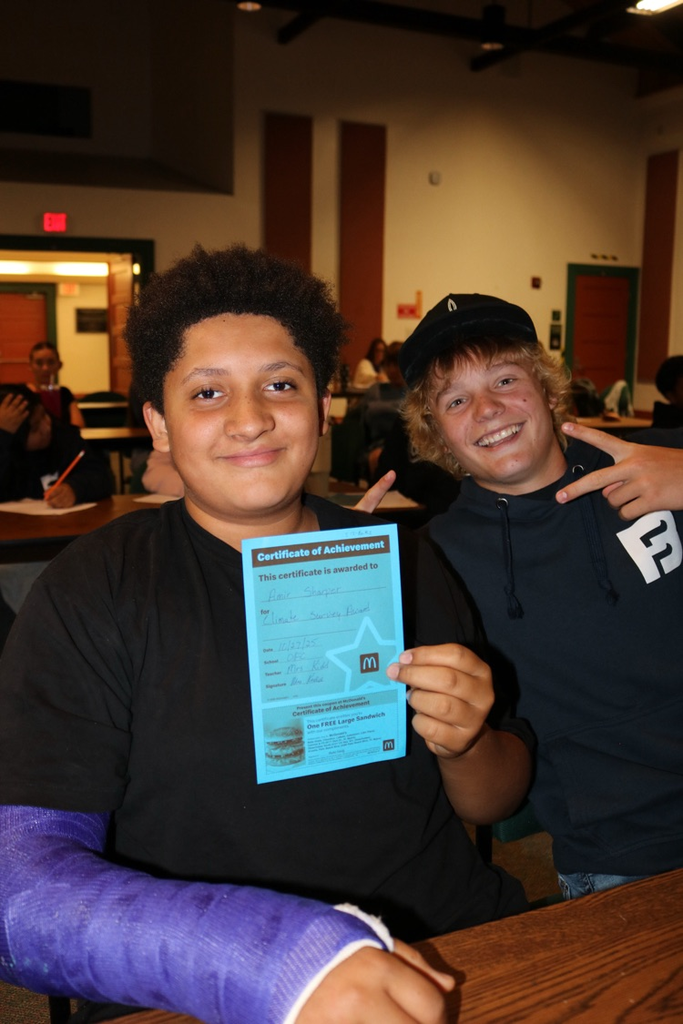 two students showing coupon for restaurant