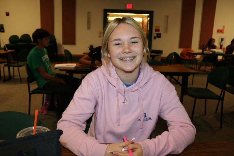 girl smiling in townhall meeting