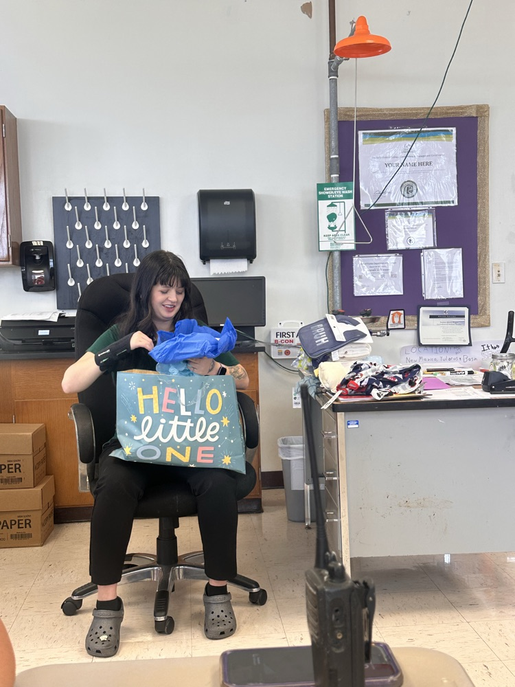 ese clerk opening baby shower gifts