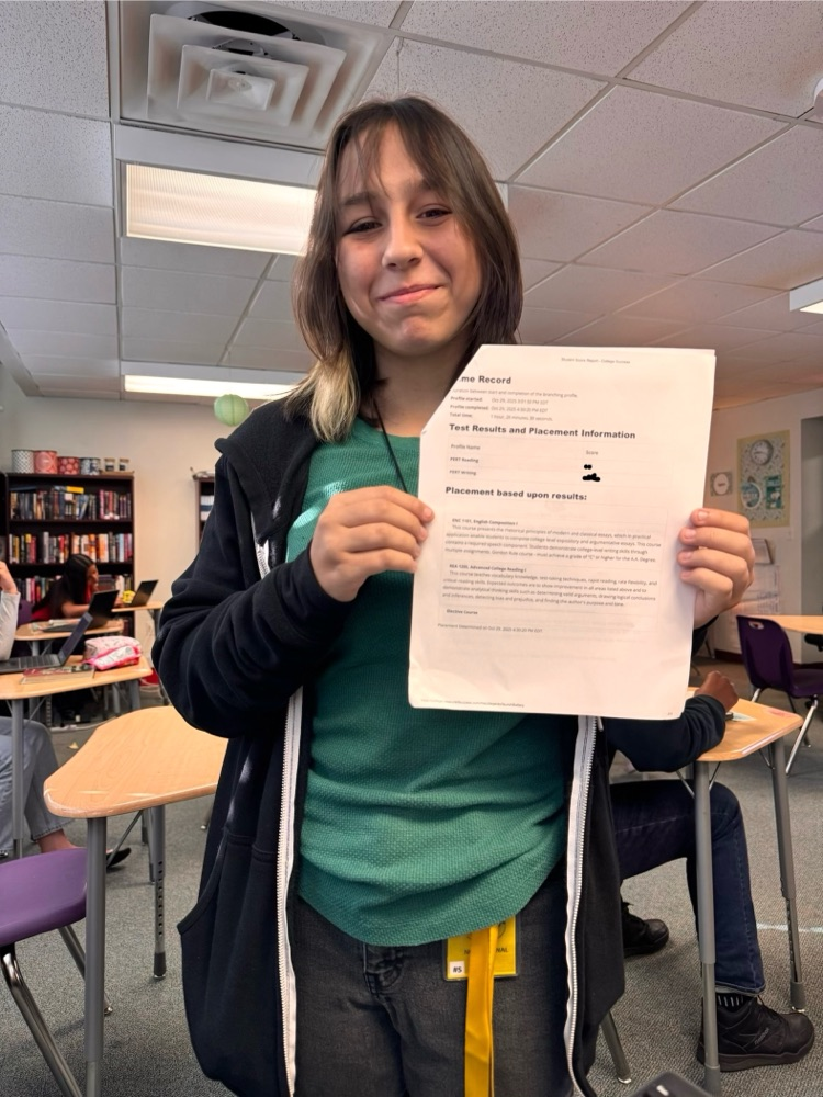 student holding pert test results report