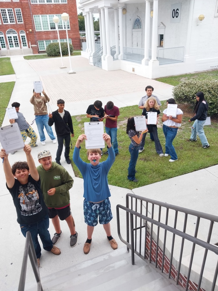class showing off notebooks outside