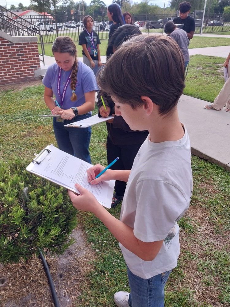 students writing in science worksheets