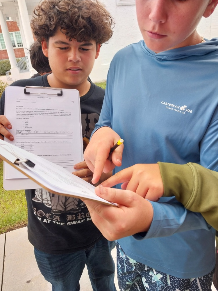 students writing in science worksheet