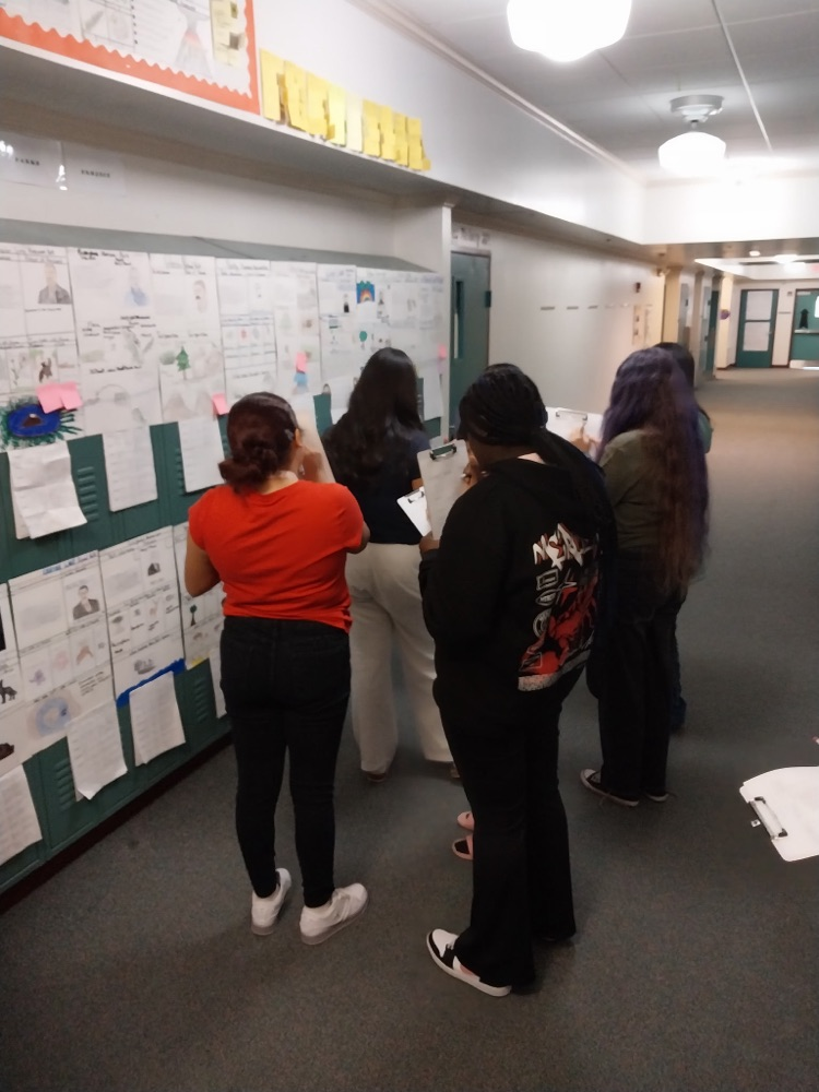 students looking at posters on lockers