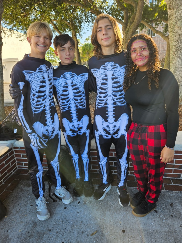 four students dressed as skeletons