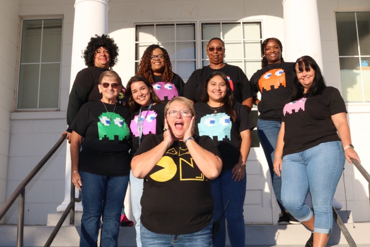 nine school staff members dressed as Pac-Man for Halloween
