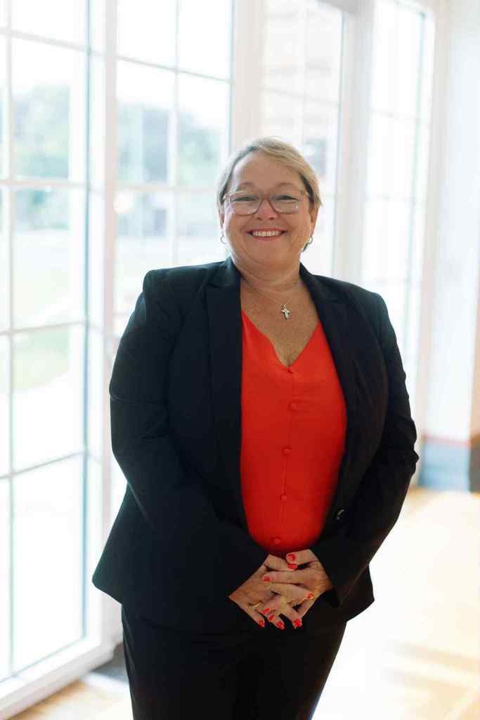 principal with black blazer smiling