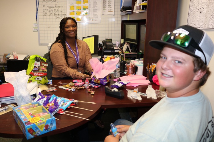 student and guidance counselor making attendance raffle baskets