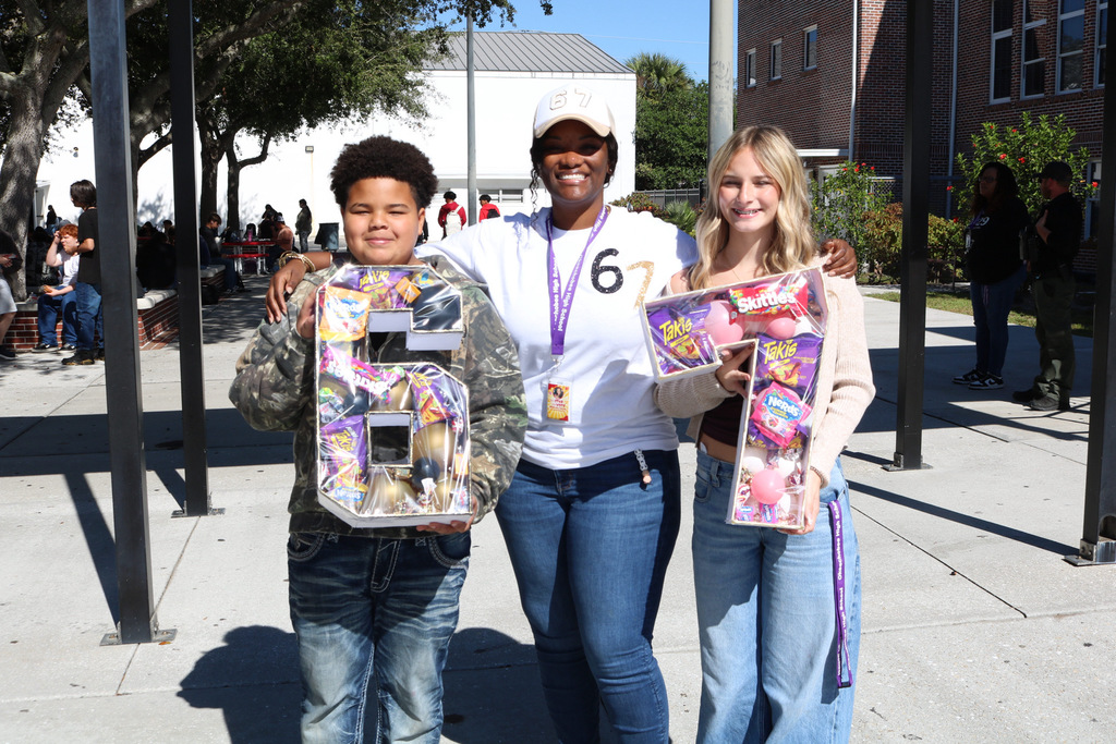 guidance counselor with two students celebrating 67 day