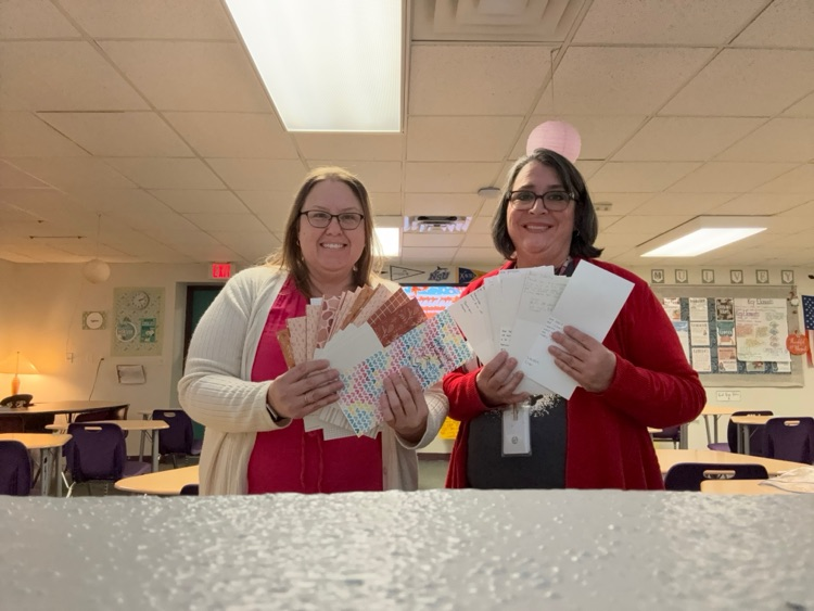 two teachers holding cards for veterans 