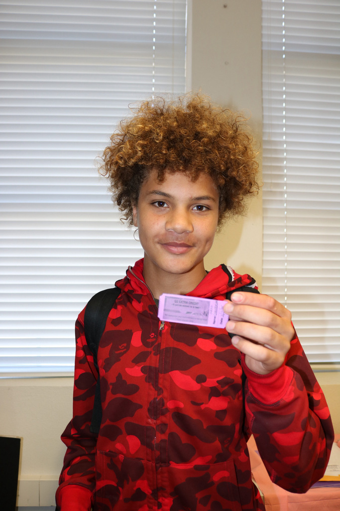 male student showing extra credit pass