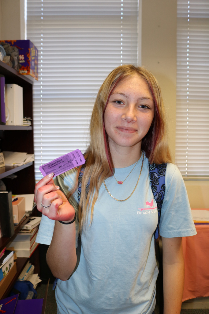 student showing extra credit passes