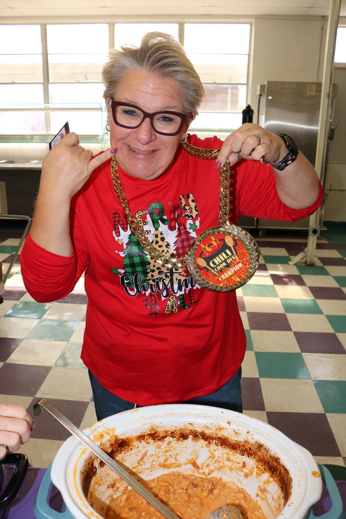 teacher holding chili winner award
