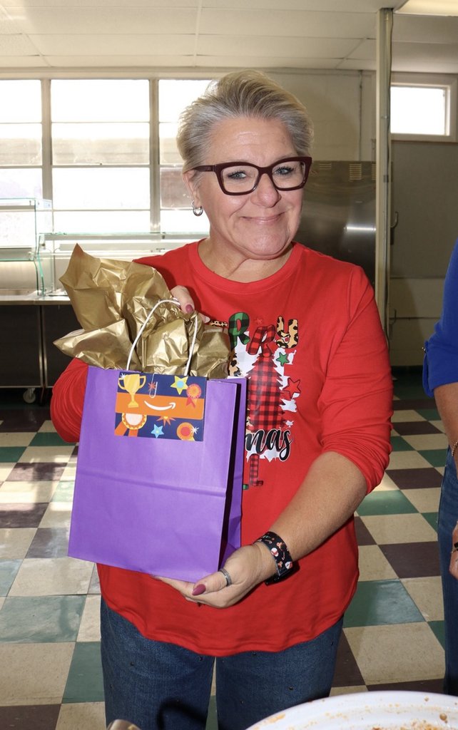 teacher holding chili winner award