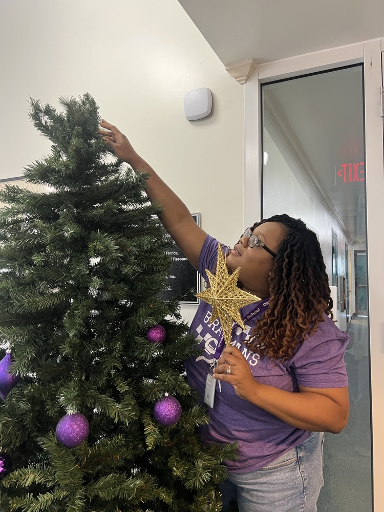 staff decorating Christmas tree