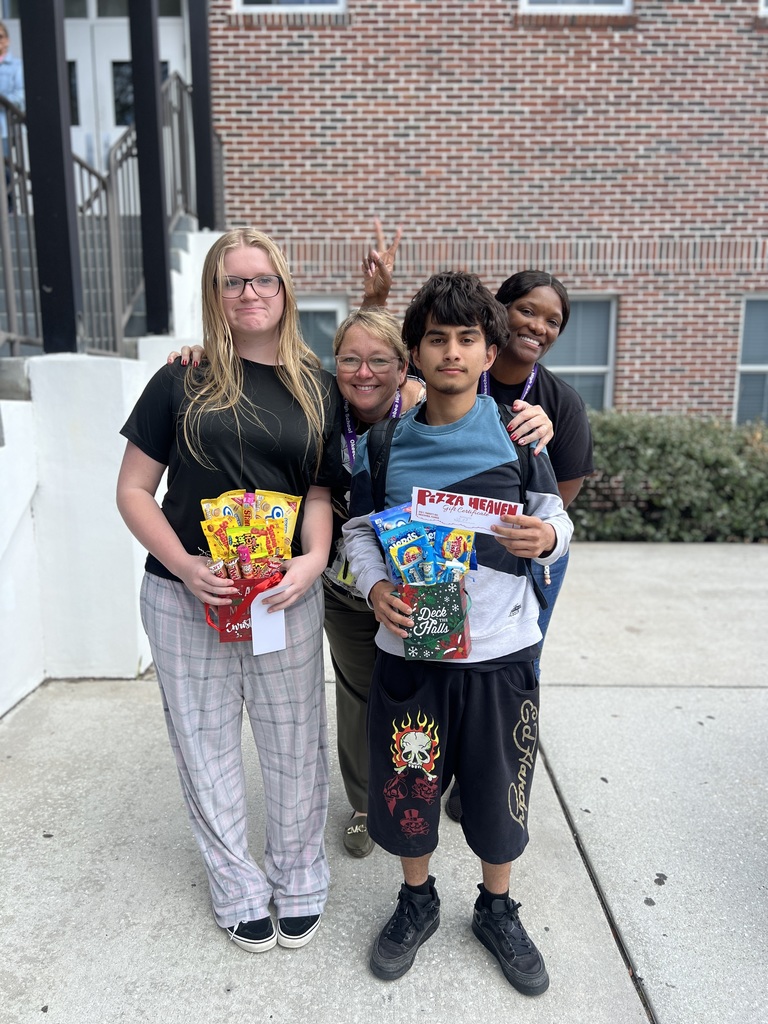 two students with principal and guidance counselor