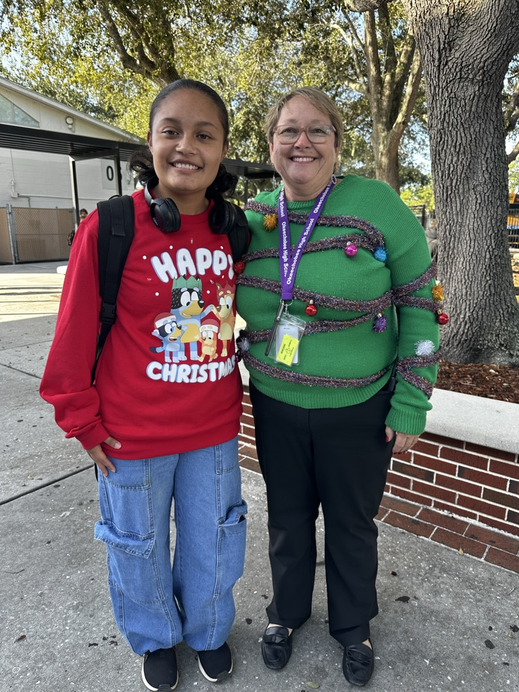 principal and teacher wearing ugly Christmas sweater