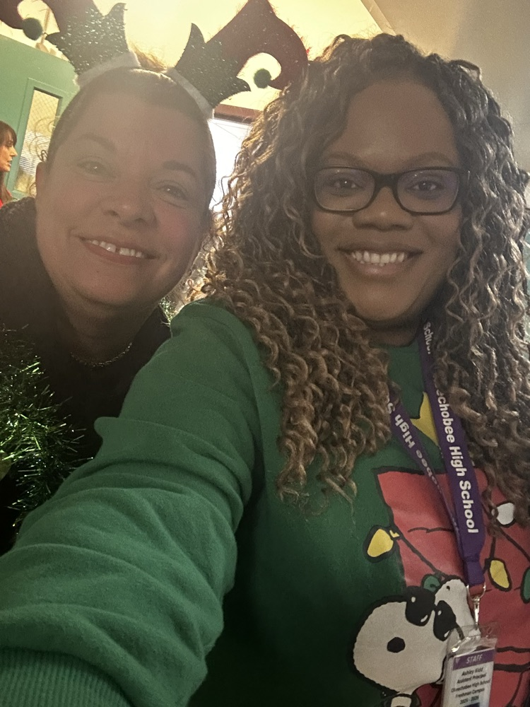 two school members dressed in ugly sweaters 