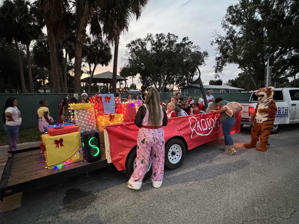 Students in Christmas outfits on Red float for parade