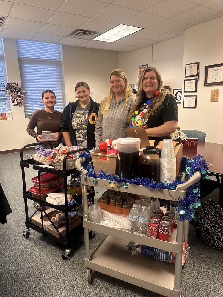 three students and sponsor with breakfast carts