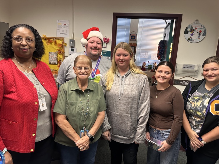 office staff and three students getting breakfast treats