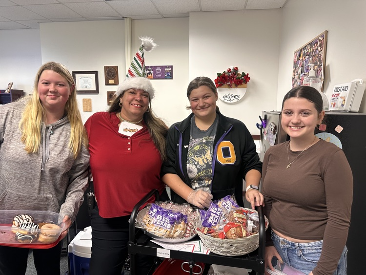 custodian with students in principal office 