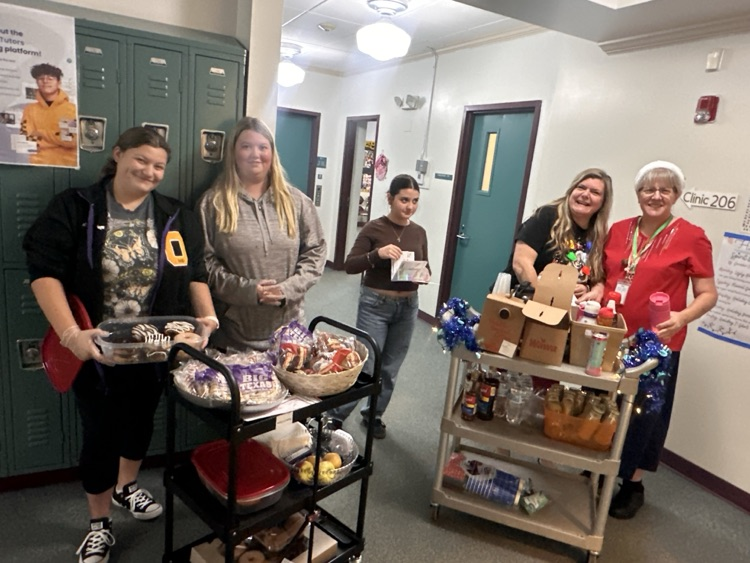 teacher and students with breakfast carts in hallway