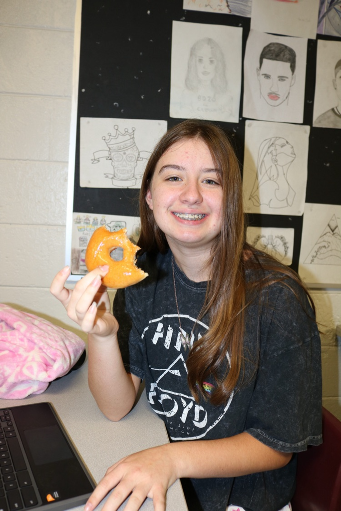 students eating donuts in art class