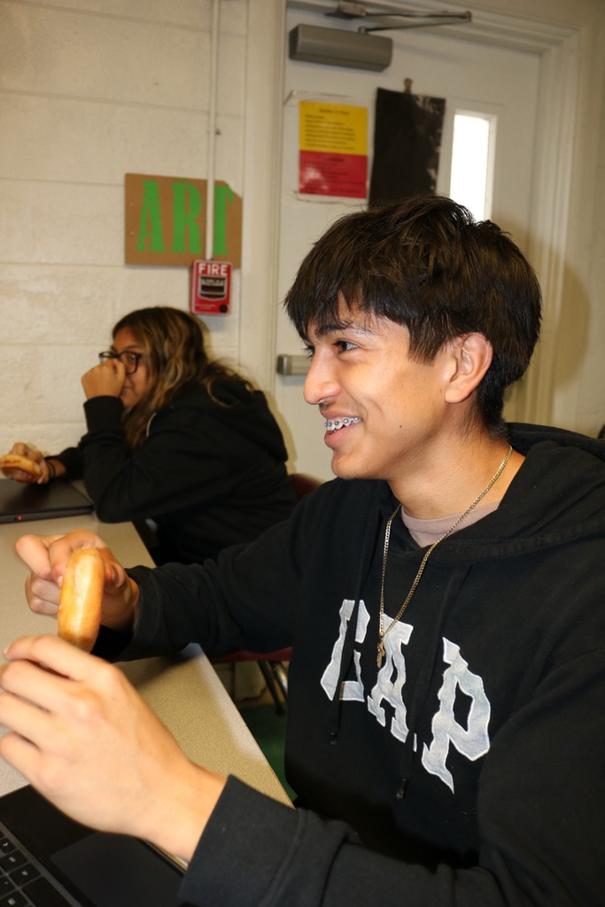 students eating donuts in art class