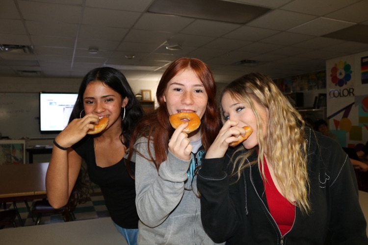 students eating donuts in art class