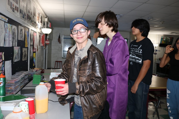 students eating donuts in art class