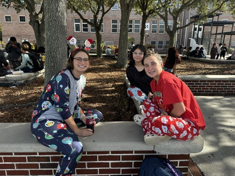 teacher with students in school courtyard