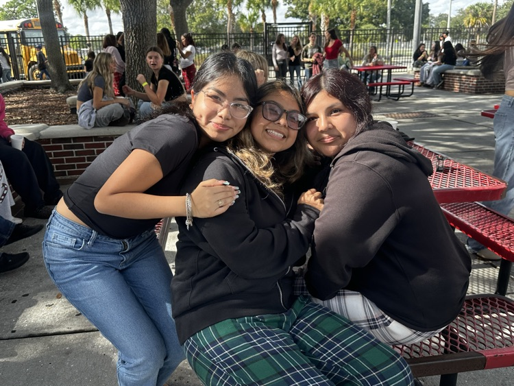 three students in school courtyard