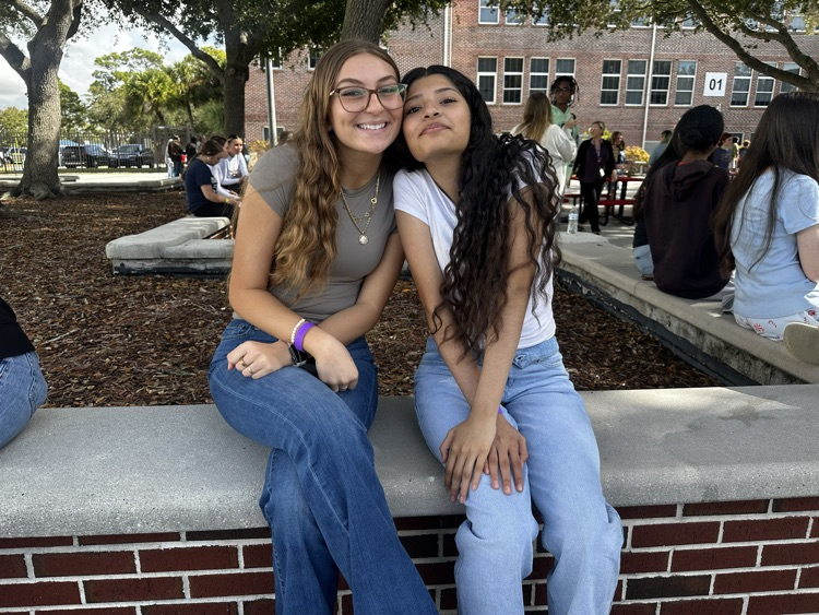 two students smiling in courtyard