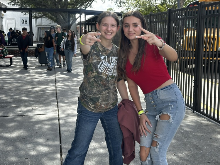 two students smiling in courtyard